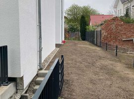 28.04.2023: Das Gelände wurde modelliert. Der Mutterboden wurde aufgebracht und der Rasen darauf gesät. Die Zuwegungen und auch der Müllplatz sind gepflastert und auch die Dachbegrünung im Hinterhof wurde bereits angelegt.